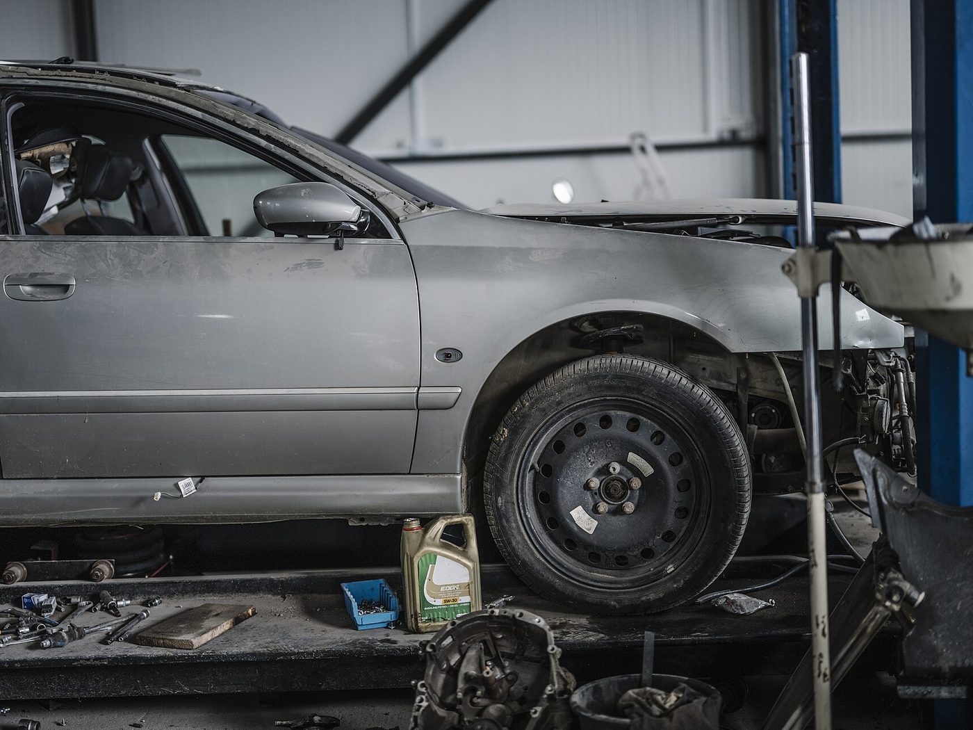 A car on a lift in an auto repair shop