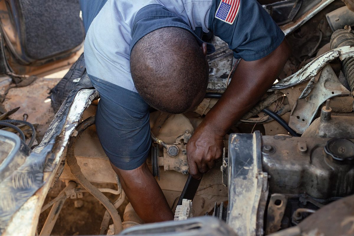 A mechanic servicing a car
